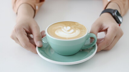 woman hand with a coffee cup  On the desk  Morning lifestyle concept