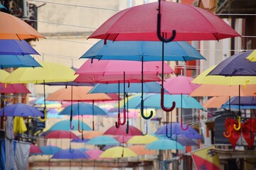Colorful umbrellas on the street in Iglesias, Sardinia, Italy