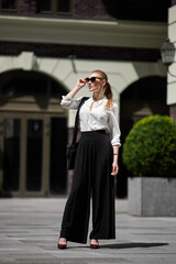 beautiful woman in sunglasses in the street
