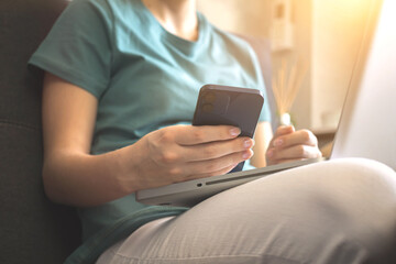 Person using mobile phone indoors in autumn weekend days
