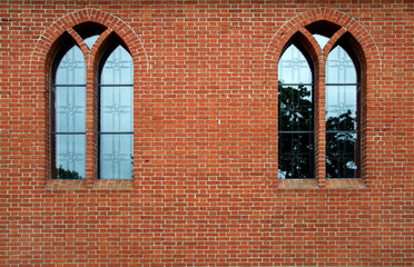 General view and architectural details of the Evangelical Augsburg Church in the village of Wejsuny in Masuria, Poland, built in 1910 in red brick in the neo-Gothic style.