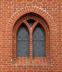 General view and architectural details of the Evangelical Augsburg Church in the village of Wejsuny in Masuria, Poland, built in 1910 in red brick in the neo-Gothic style.