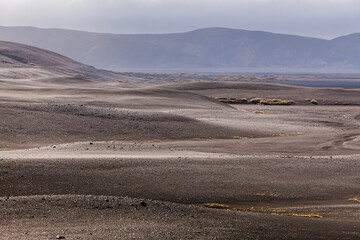Desolate landscape in the central highlands of Iceland with fields of volcanic debris and ash