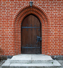 General view and architectural details of the Evangelical Augsburg Church in the village of Wejsuny in Masuria, Poland, built in 1910 in red brick in the neo-Gothic style.
