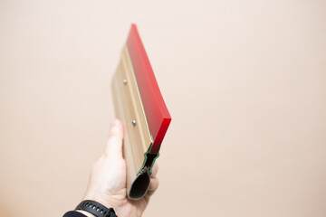 Hand with squeegee for serigraphy silk screen print process at clothes factory
