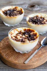 Rice pudding on wood floor. Rice pudding is a dessert made with rice and milk.