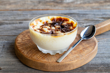 Rice pudding on wood floor. Rice pudding is a dessert made with rice and milk.