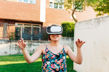 Woman in VR headset exploring another world. Metaverse concept.