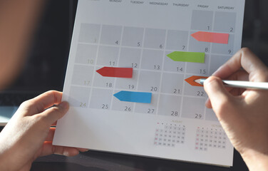 Event planner timetable agenda plan on organize schedule event. Business woman using mobile phone...