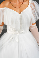 Fototapeta na wymiar White dress of the bride. Light fabric texture. Traditional wedding wear.