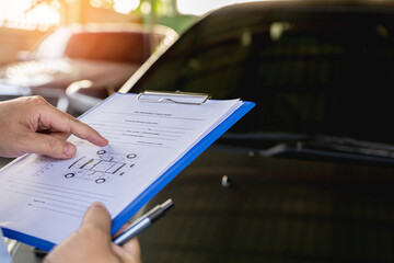 A man check document car damage from repair in service shop and check the integrity