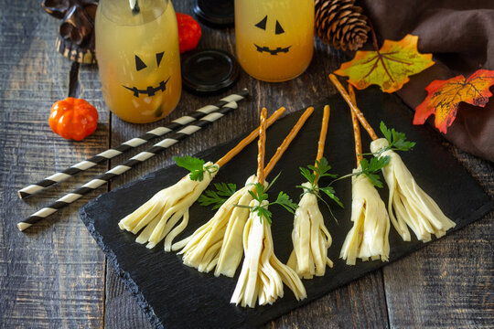 Halloween funny idea for party food. Halloween creative cheese snack on a wooden table.