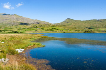 Snowdonia, Wales, Llyn y Gader. Beautiful lake by Beddgelert forest. Tranquil mountain scene on a sunny summers day.  Landscape aspect shot. Copy space.