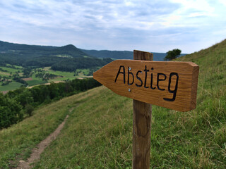 Closeup view of brown wooden sign with German text 