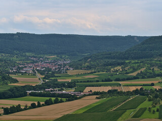 Fototapeta na wymiar View of the northern foothills of Swabian Alb with forests, agricultural fields, rural village Hepsisau, part of Weilheim an der Teck, Germany.
