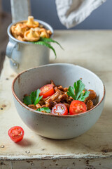 Delicious fried noble mushrooms with cherry tomatoes.
