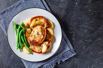 pork chops in apple cider cream sauce on a plate