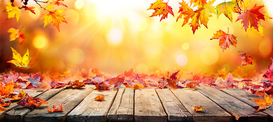 Naklejka na ściany i meble Fall Table - Autumn Leaves Falling On Wooden Plank