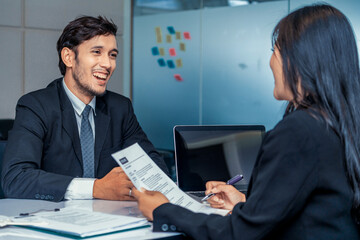 Human resource manager interviewing the male employment candidate in the office room. Happy job...