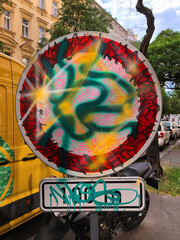 Street sign with psychedelic graffiti in the city