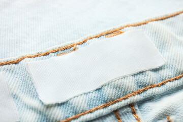 Cotton laundry care clothing label on fabric texture with place for text on fabric texture. Clothes...