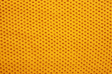 Knitted sweater texture. Abstract knitted fabric as background. Yellow wooled pattern, copy space text, top view, macro view

