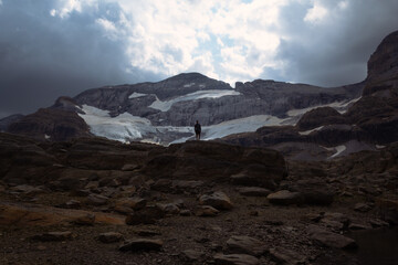 Mountaineer in a cloudy day near snow in Ibon de Marboure.