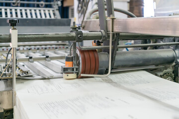 The offset press in the production process is in the printing factory