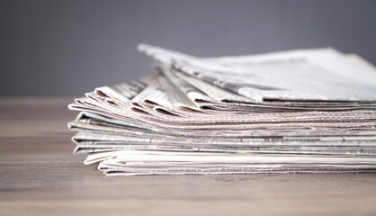 Newspapers on the wooden table.