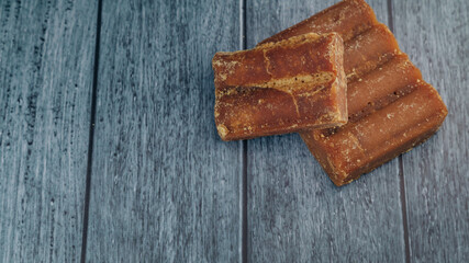 panela, from sugar cane, for different preparations on a gray background, made in Colombia.