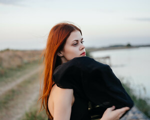 Red-haired woman black veil nature posing