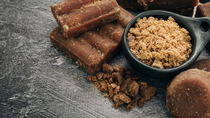 panela, from sugar cane, for different preparations on a gray background, made in Colombia.