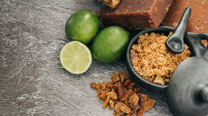 panela, from sugar cane and lemon, for different preparations on gray background, made in Colombia.