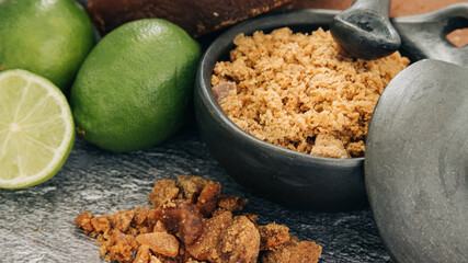 panela, from sugar cane and lemon, for different preparations on gray background, made in Colombia.