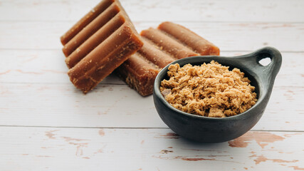 panela, from sugar cane, for different preparations on a white wooden base, made in Colombia.