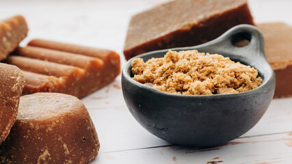 panela, from sugar cane, for different preparations on a white wooden base, made in Colombia.