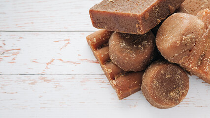 panela, from sugar cane, for different preparations on a white wooden base, made in Colombia.