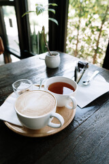 Foamed milk latte heart, Cup of hot coffee on the table in a cafe