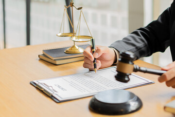 Attorney's Office Judge with hammer and scales with laptop on desk, businessman in suit or lawyer working on paperwork. Law, Guidance and Justice Concepts