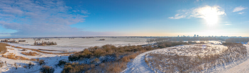 Snowy landscape with hills and meadows in Buytenpark Zoetermeer, the Netherlands