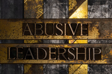 Abusive Leadership text on textured lead over grunge copper and vintage gold background