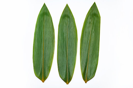 Three bamboo leaves for serving Japanese food on white background.