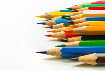 Fototapeta premium Right side view of various colored pencils. placed isolated on white background and colored pencils in close-up.Concept art Text copy space and office