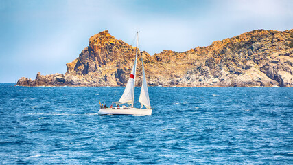 Incredible view of sailboat sailing near the cliffs of  Santa Teresa Gallura