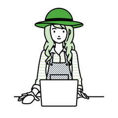 デスクで座ってPCを使っている農家の女性