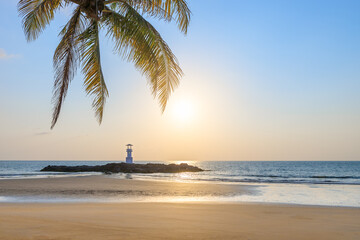 Khao Lak beach and light beacon or lighthouse for navigation with coconut tree leave, famous travel destination and resort near Phuket, Phang-Nga, Thailand