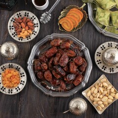 Ramadan Food and Drink Concept with Copy Space on Wooden Table. Dates Fruit, Nuts, Seed, Coffe, Tea, Honeyand Ketupat. Arabian Mosleem Style Food for Ied al Fitr