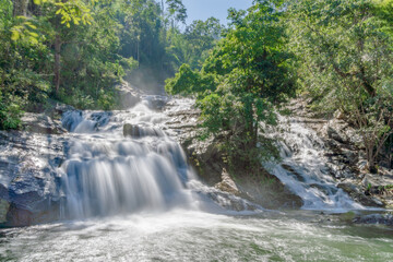 Fototapeta na wymiar Khlong Nam Lai Waterfall, large and exotic waterfall in tropical forest in National Park, Kamphaeng Phet, Thailand