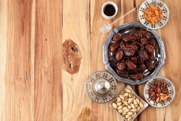 Ramadan Food and Drink Concept with Copy Space on WOoden Table. Dates Fruit, Nuts, Seed, Coffe, Tea, Honey. Arabian Style Food