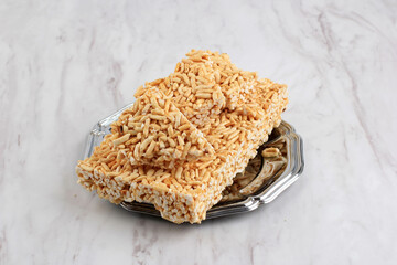 Kue Gipang, Jipang, Bipang or Teng teng Beras is Indonesian Traditional Cereal made from Rice Crispy with Sticky Sugar. Taste Sweet and Crispy, Copy Space on White background